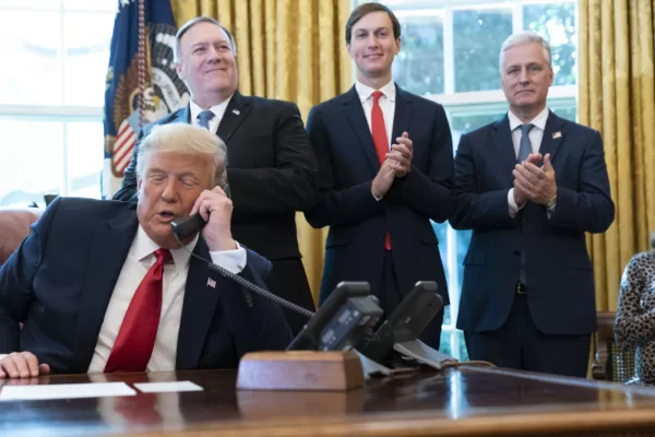President Donald Trump talks on a phone call with the leaders of Sudan and Israel, as Secretary of State Mike Pompeo, left, White House senior adviser Jared Kushner, and National Security Adviser Robert O’Brien, applaud in the Oval Office of the White House, Friday, Oct. 23, 2020, in Washington. (AP Photo/Alex Brandon)