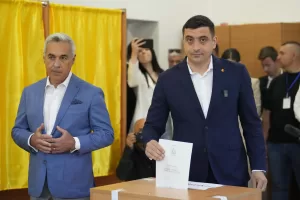 Presidential candidate George Simion, right, casts his vote next to Calin Georgescu, winner of the first round of last year’s annulled election, during the first round of the presidential election redo in Bucharest, Romania, Sunday, May 4, 2025. (AP Photo/Vadim Ghirda)